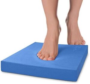 Bare feet standing on a foam balance pad during a physiotherapy balance exercise